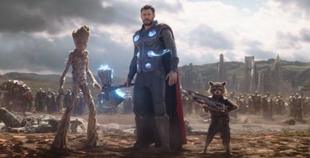 Groot stands in the battlefield along with Thor and Rocket Raccoon,